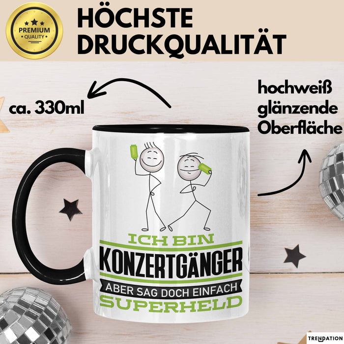 Konzertgänger Geschenk Tasse Ich Bin Konzertgänger Aber Sag Doch Einfach Superheld Lustige Geschenkdiee für Konzertgänger Kaffee-Becher Schwarz Trendation