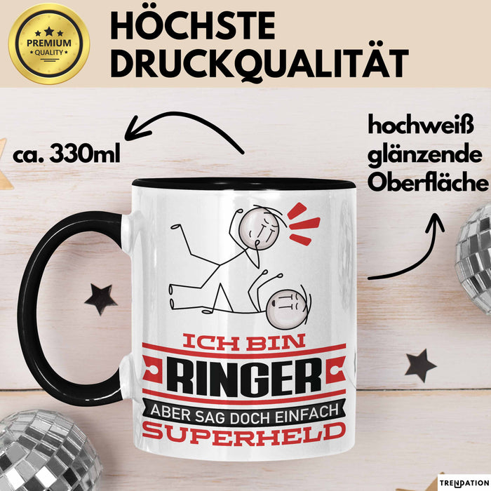 Ringer Geschenk Tasse Ich Bin Ringer Aber Sag Doch Einfach Superheld Lustige Geschenkdiee für Ringer Kaffee-Becher Schwarz Trendation