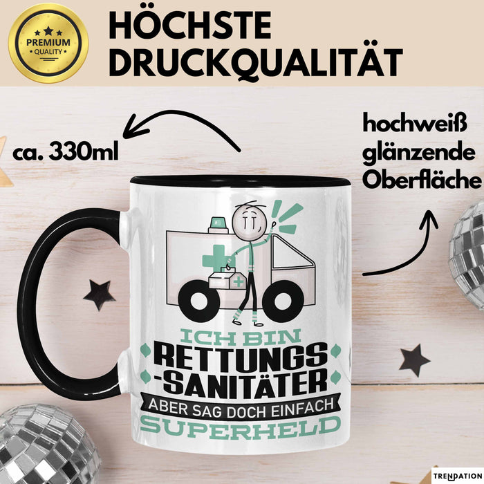 Rettungssanitäter Geschenk Tasse Ich Bin Rettungssanitäter Aber Sag Doch Einfach Superheld Lustige Geschenkdiee für Rettungssanitäter Kaffee-Becher Schwarz Trendation