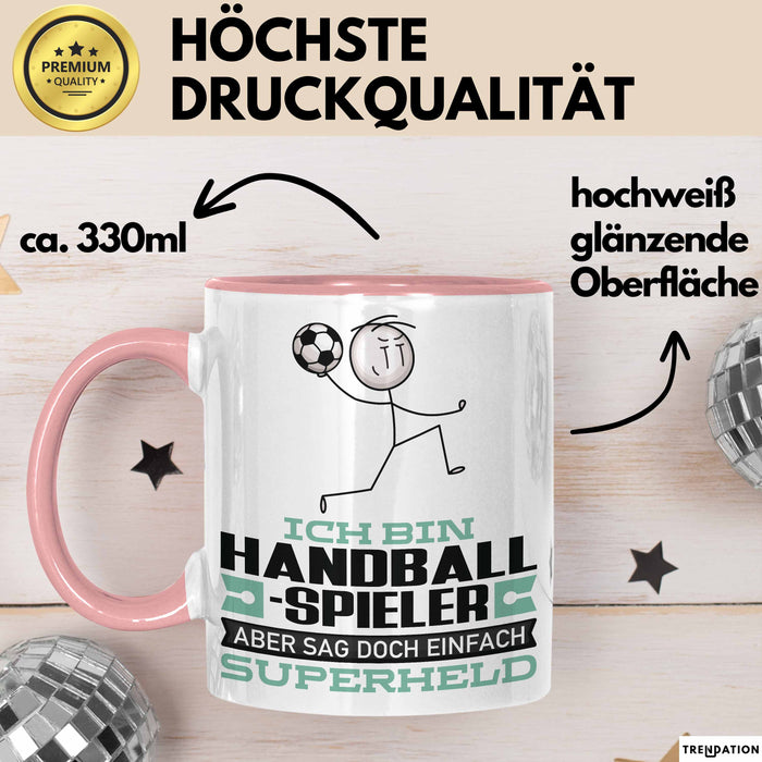 Handballspieler Geschenk Tasse Ich Bin Handballspieler Aber Sag Doch Einfach Superheld Lustige Geschenkdiee für Handballspieler Kaffee-Becher Rosa Trendation