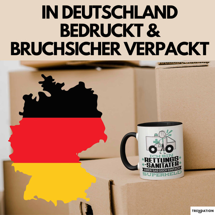 Rettungssanitäter Geschenk Tasse Ich Bin Rettungssanitäter Aber Sag Doch Einfach Superheld Lustige Geschenkdiee für Rettungssanitäter Kaffee-Becher Schwarz Trendation